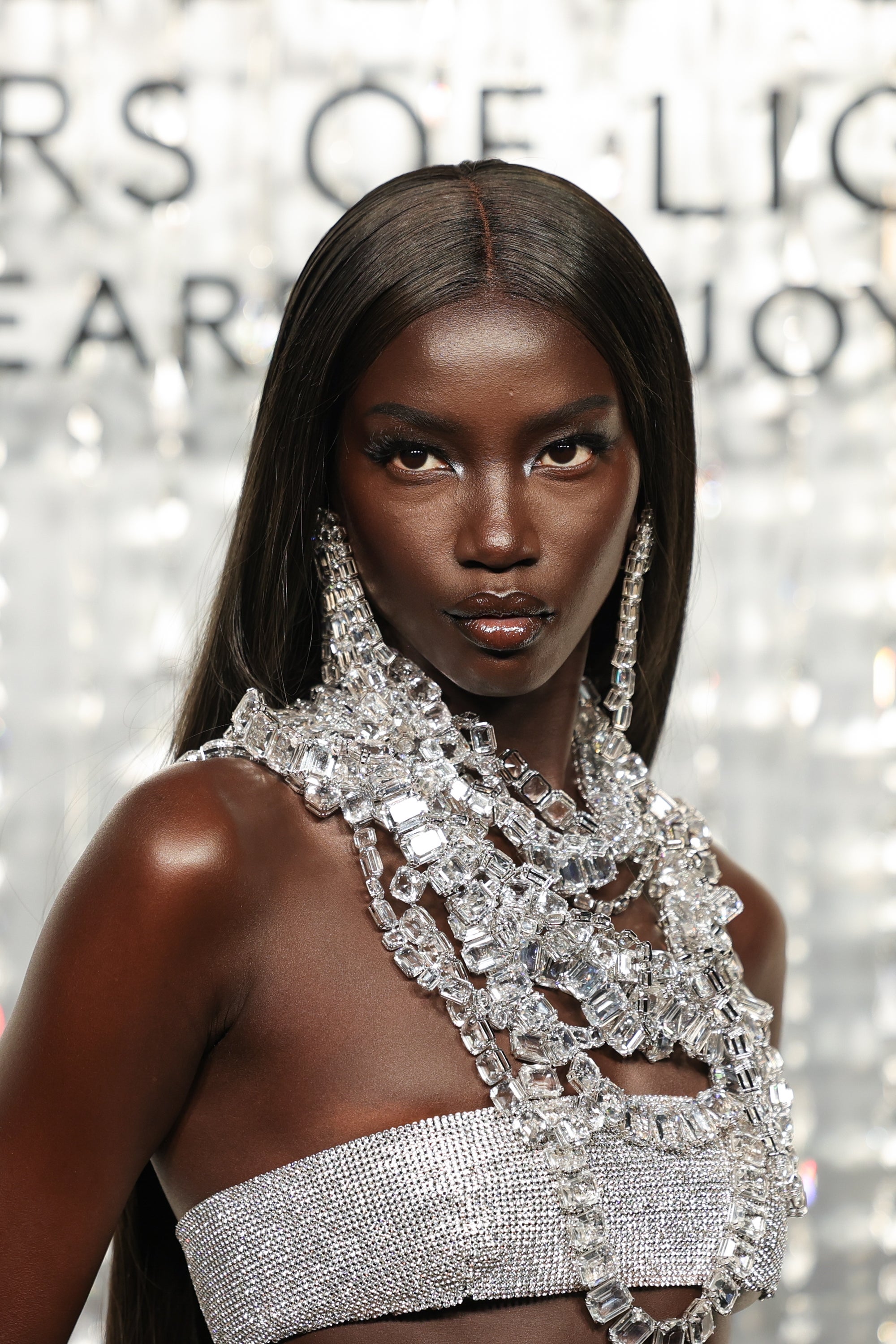 Anok Yai wearing an elegant crystal-adorned formal and glamorous jewelry astatine a ceremonial event