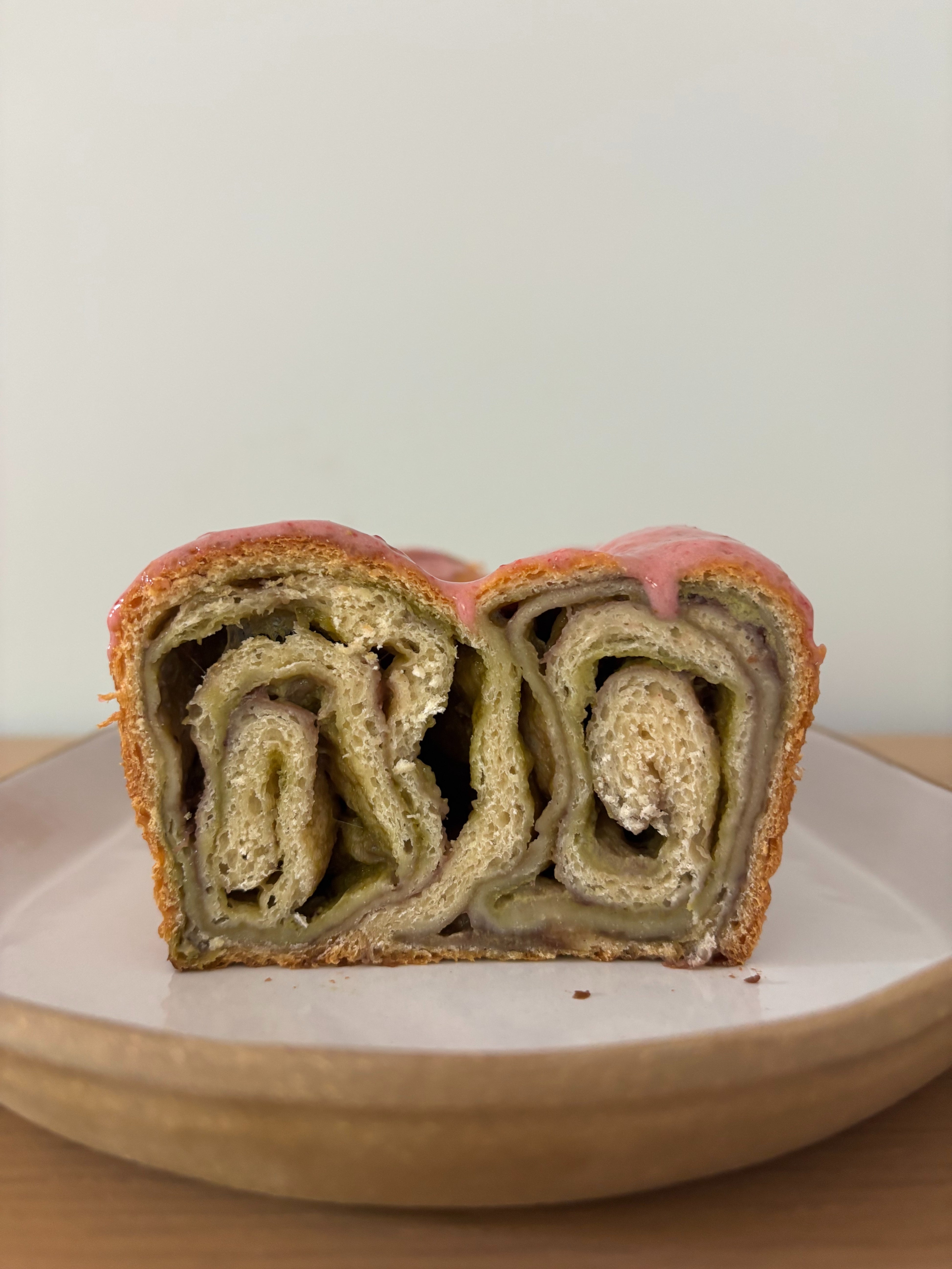 Bread roll with swirled layers on a white plate