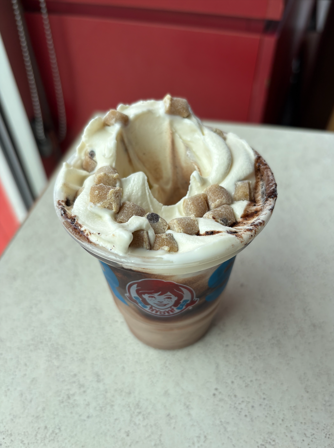 Wendy's Cookie Dough Frosty Fusion with vanilla soft serve and cookie dough pieces