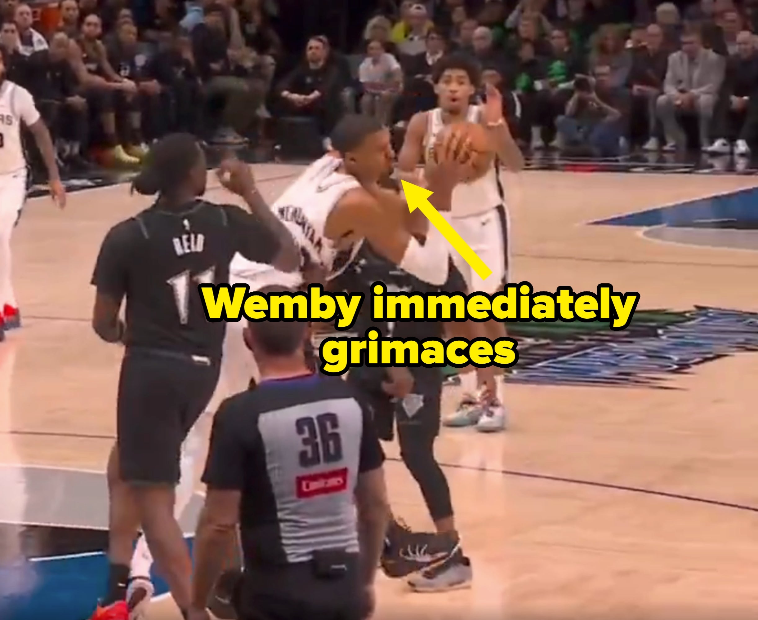 Basketball crippled  enactment   with players attempting to artifact  a shot; referee observes the play