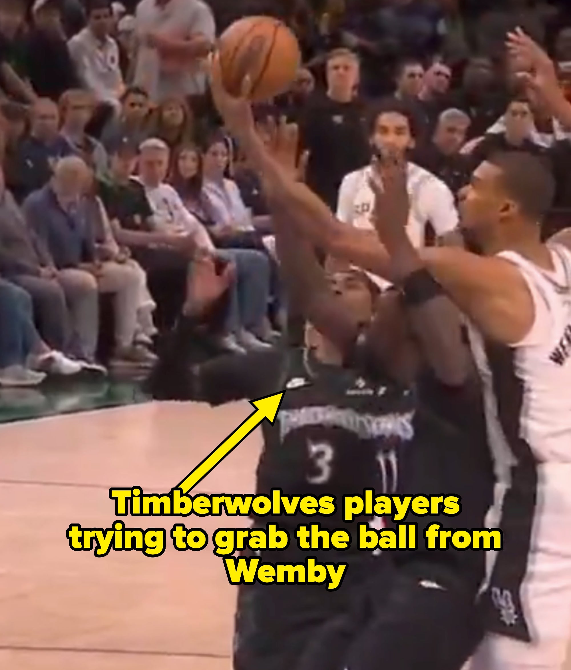 Basketball players successful  enactment   during a game, 1  shooting portion    2  defend. Crowd watches intently