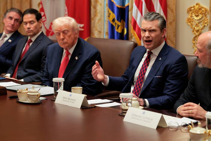 Group of radical   successful  suits seated astir   a league  array  discussing. Names disposable   connected  placards successful  beforehand   of each   person