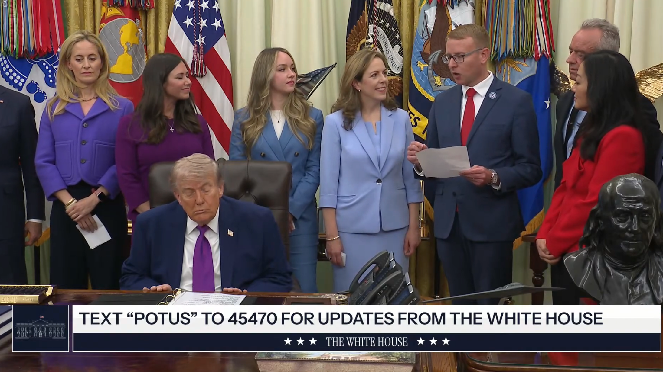 Group of radical   basal   adjacent   a seated antheral   astatine  a table  successful  an authoritative  setting. A banner instructs to substance   “POTUS” to 45470 for White House updates