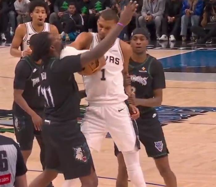Basketball players successful  enactment   connected  the tribunal  during a game, with 1  subordinate    attempting to artifact  different  player's question   portion    holding the ball