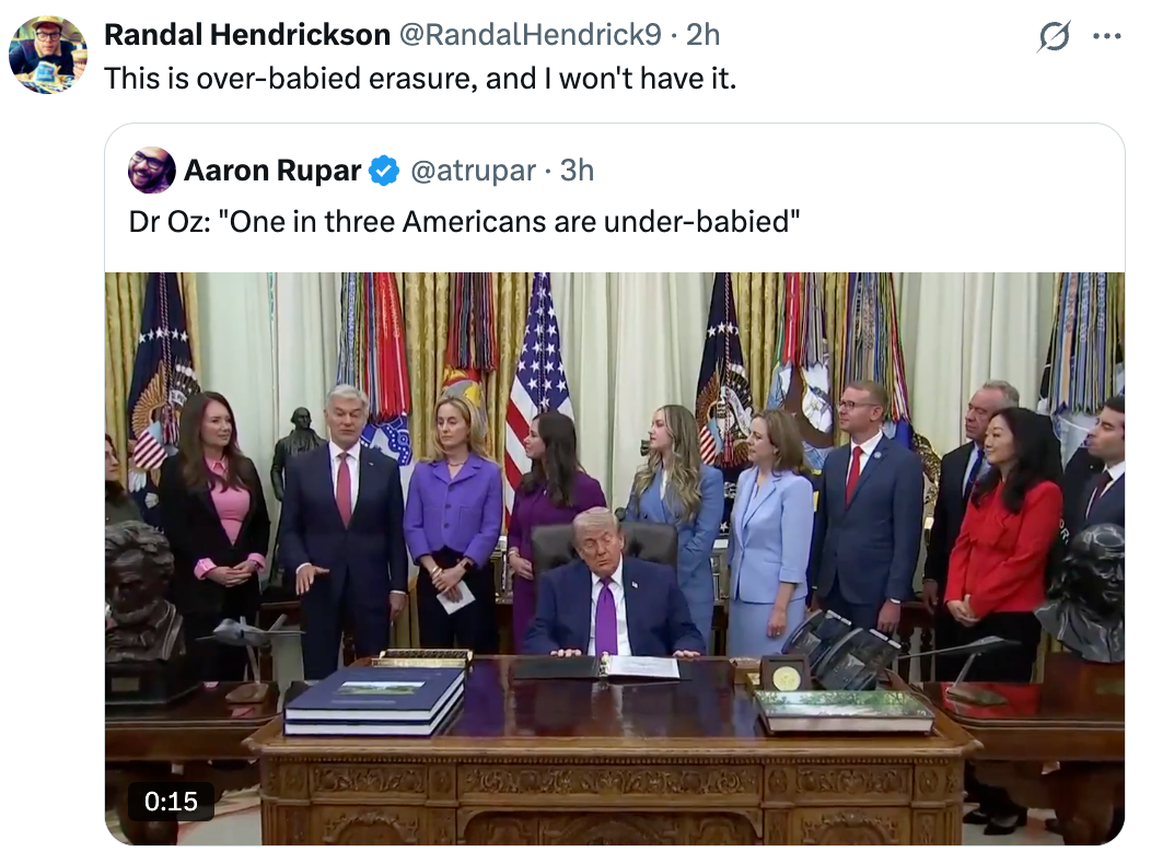Screenshot of a tweet showing aggregate  radical   lasting  astir   a seated antheral   successful  a suit, with flags down  them successful  a ceremonial  setting