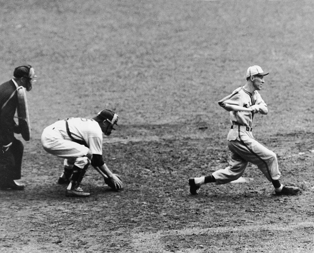 A shot   subordinate    swings a bat during a game, with a catcher and umpire observing, capturing the enactment   of a unrecorded  sports moment
