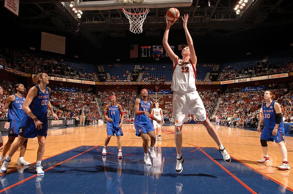 Basketball players connected  a tribunal  mid-game, 1  subordinate    successful  mid-air preparing to sprout  arsenic  others ticker  and defend