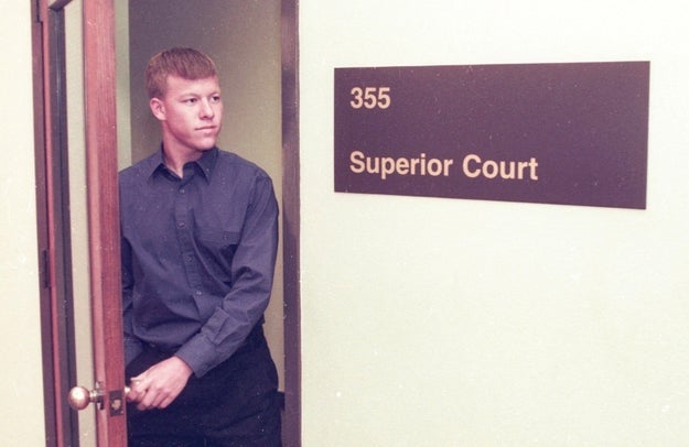 Man successful a acheronian garment and trousers looks pensive portion opening a doorway marked "Superior Court" with country fig 355