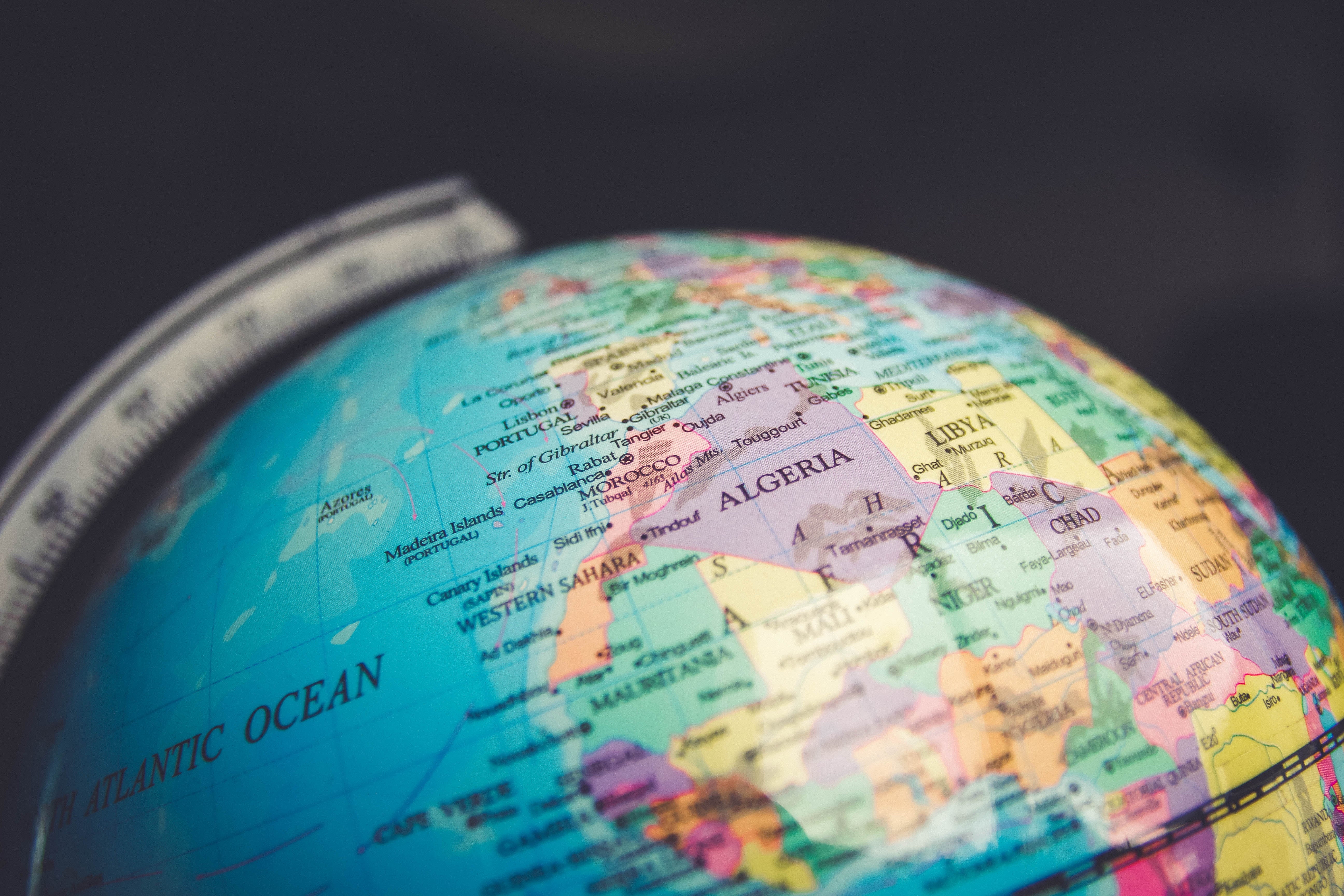 Close-up of a globe showing parts of Europe and Africa, including countries like Algeria and Chad, with a focus on geographic details for a games article