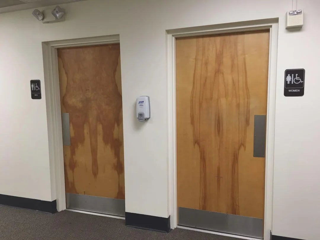 Two restroom doors with signs indicating 1  is accessible and vacant