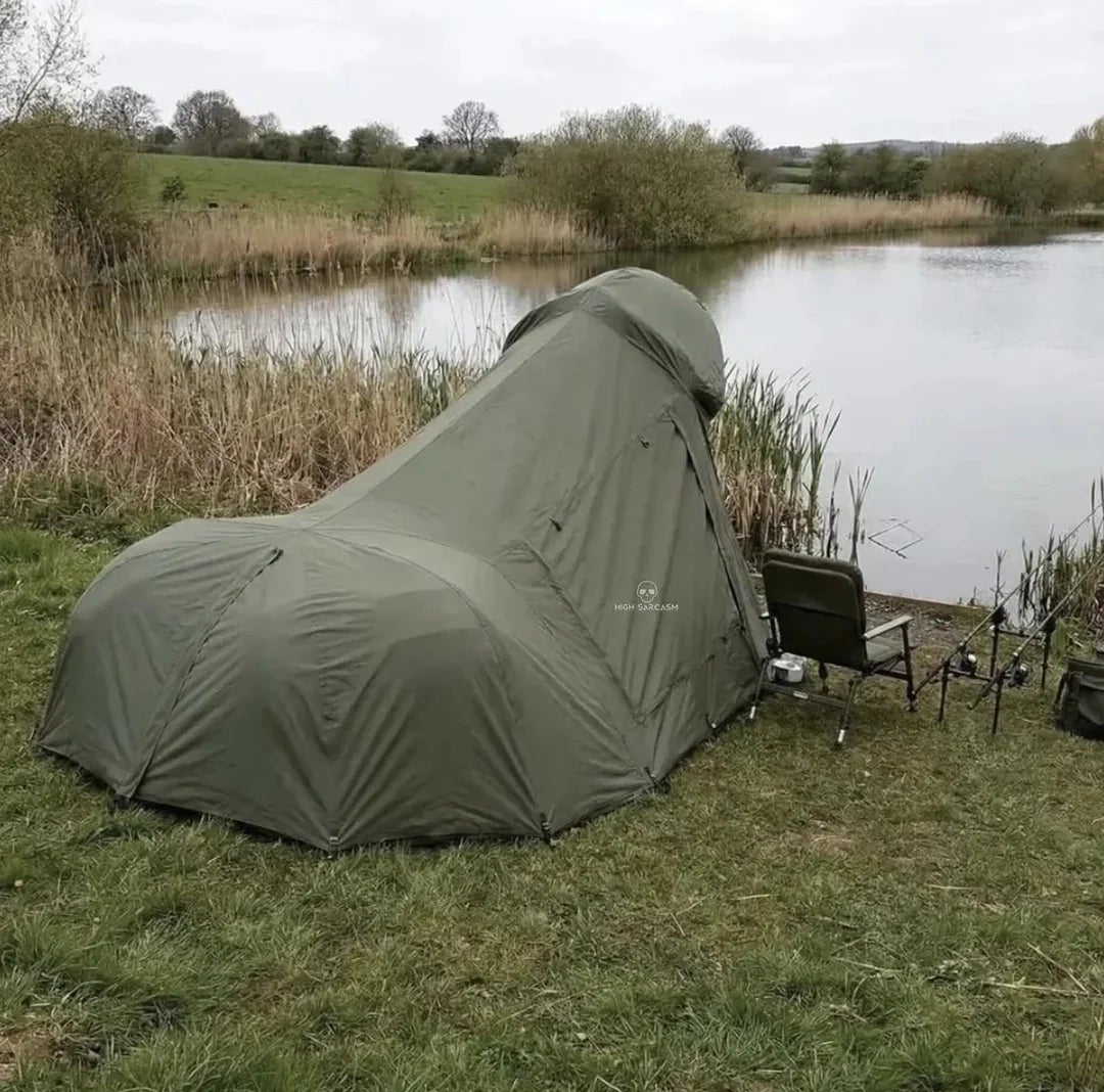 Tent pitched by a serene lakeside, with sportfishing  cogwheel  nearby, surrounded by writer  and trees