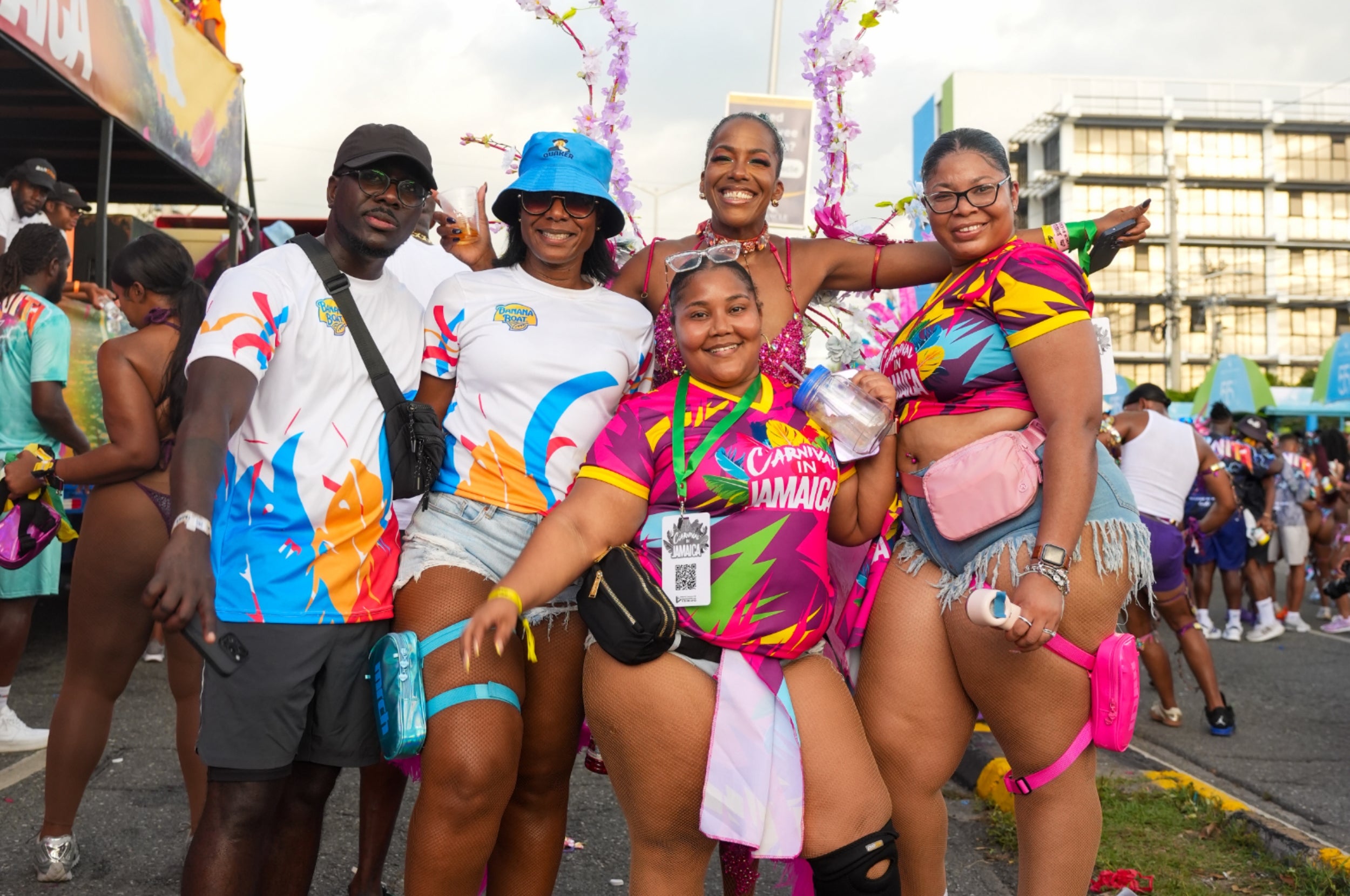 A group of friends enjoying a vibrant outdoor festival, wearing colorful carnival attire