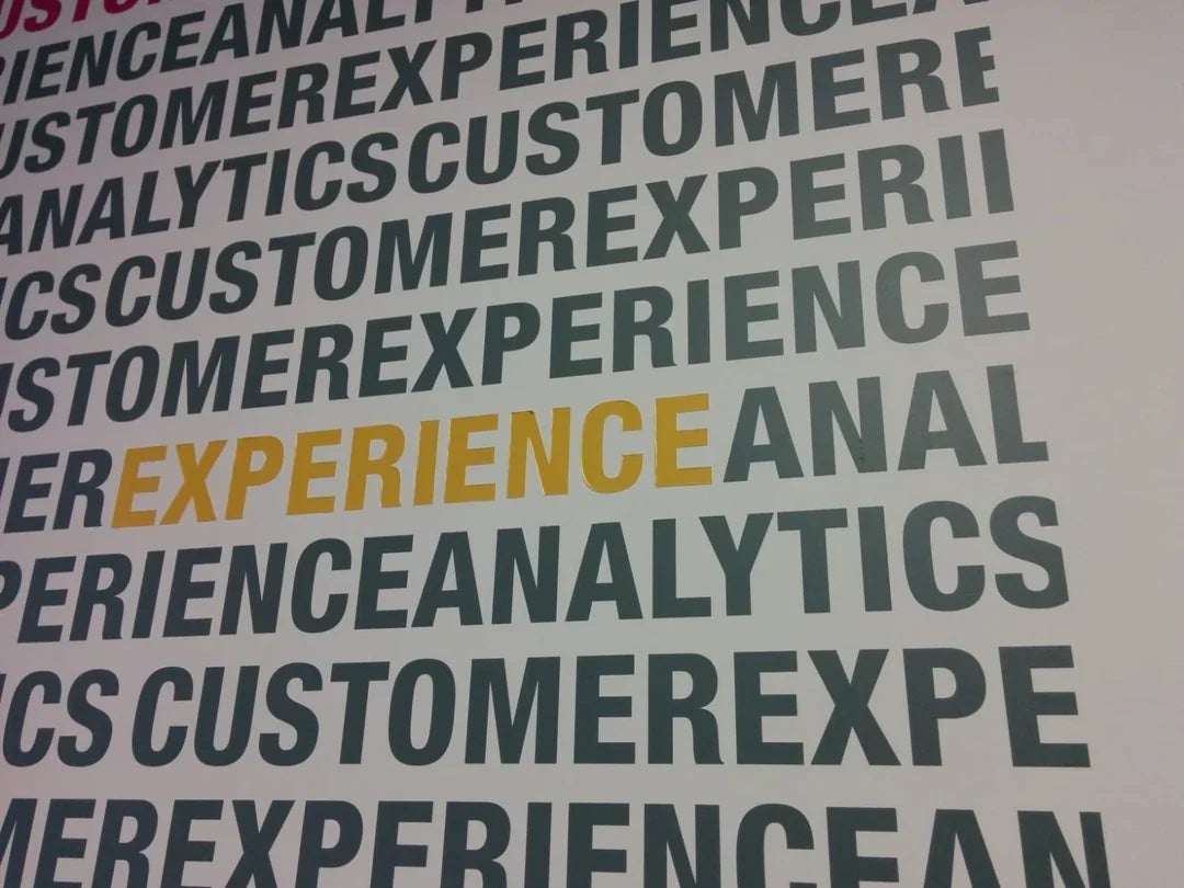 Text repeatedly says "CUSTOMER EXPERIENCE ANALYTICS," with "EXPERIENCE" highlighted