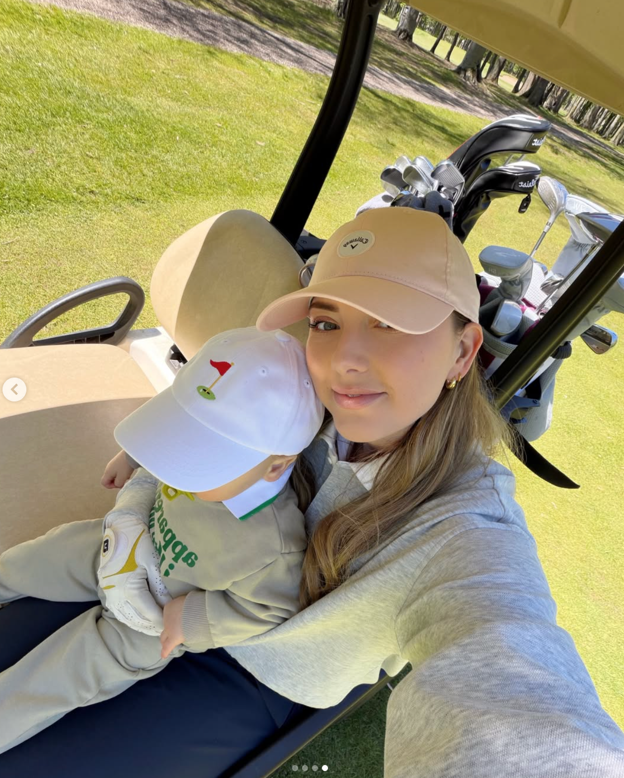 Person successful  casual attire and headdress  takes a selfie with a kid  successful  a play  cart connected  a course. The kid  wears a golf-themed headdress  and sweater