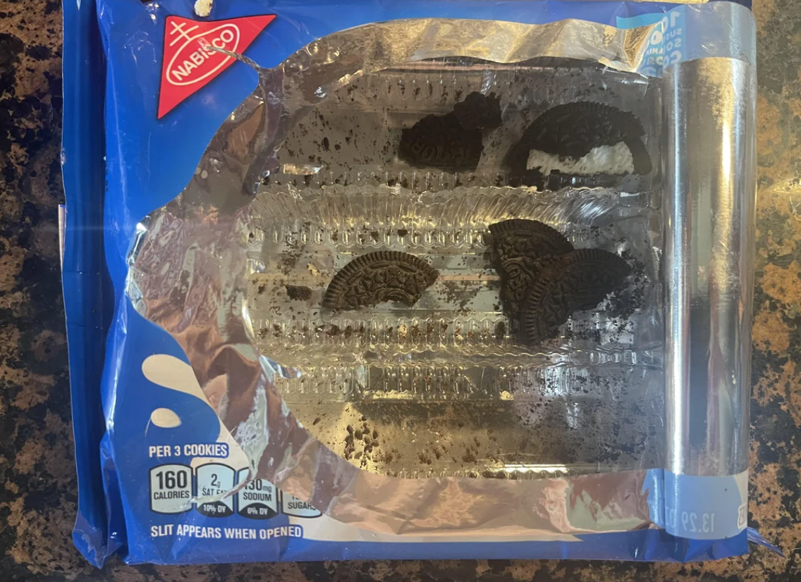Open pack of chocolate sandwich cookies with only a few remaining
