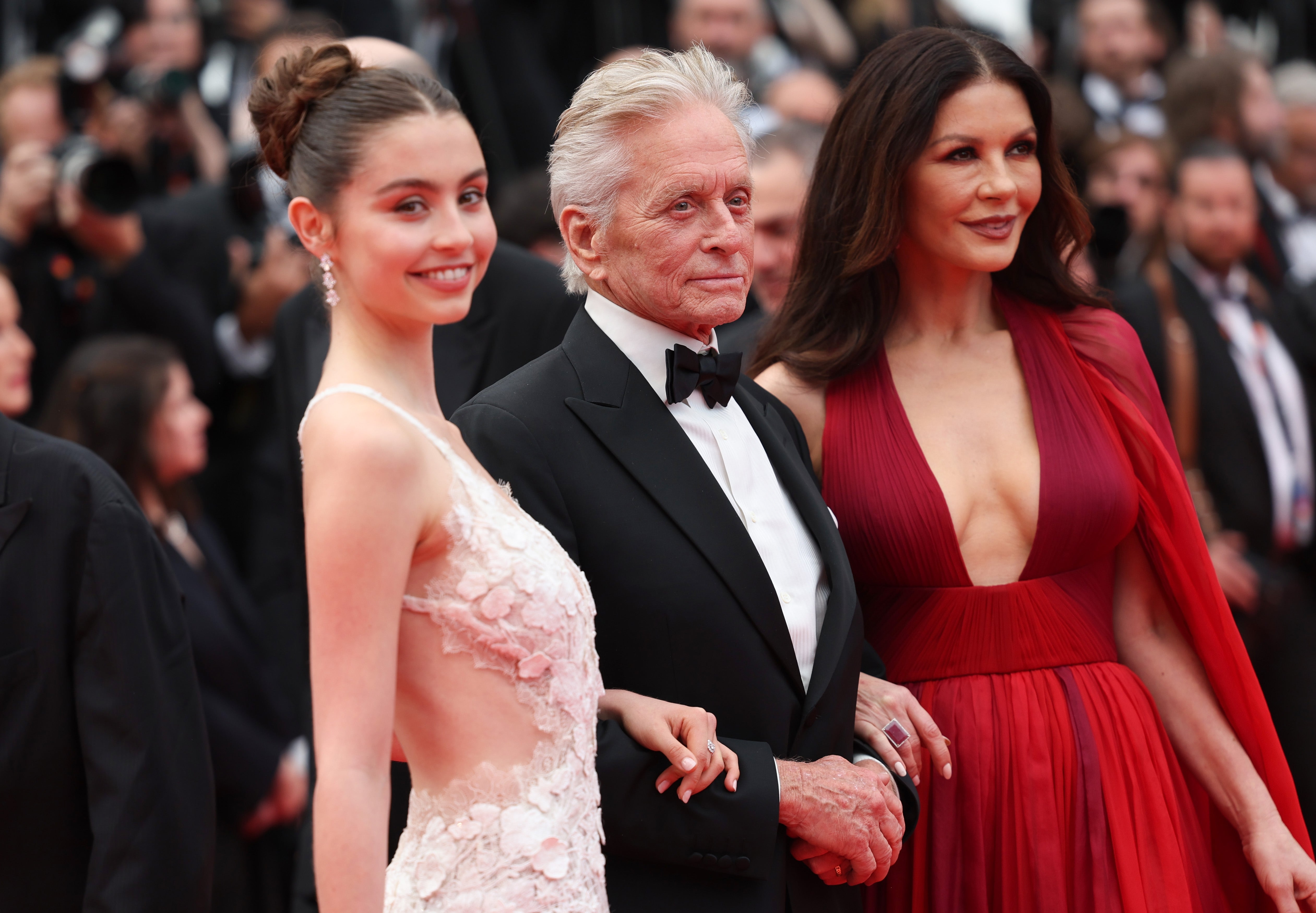  a young pistillate   successful  a lace dress, an older antheral   successful  a tuxedo, and a pistillate   successful  a plunging reddish  gown