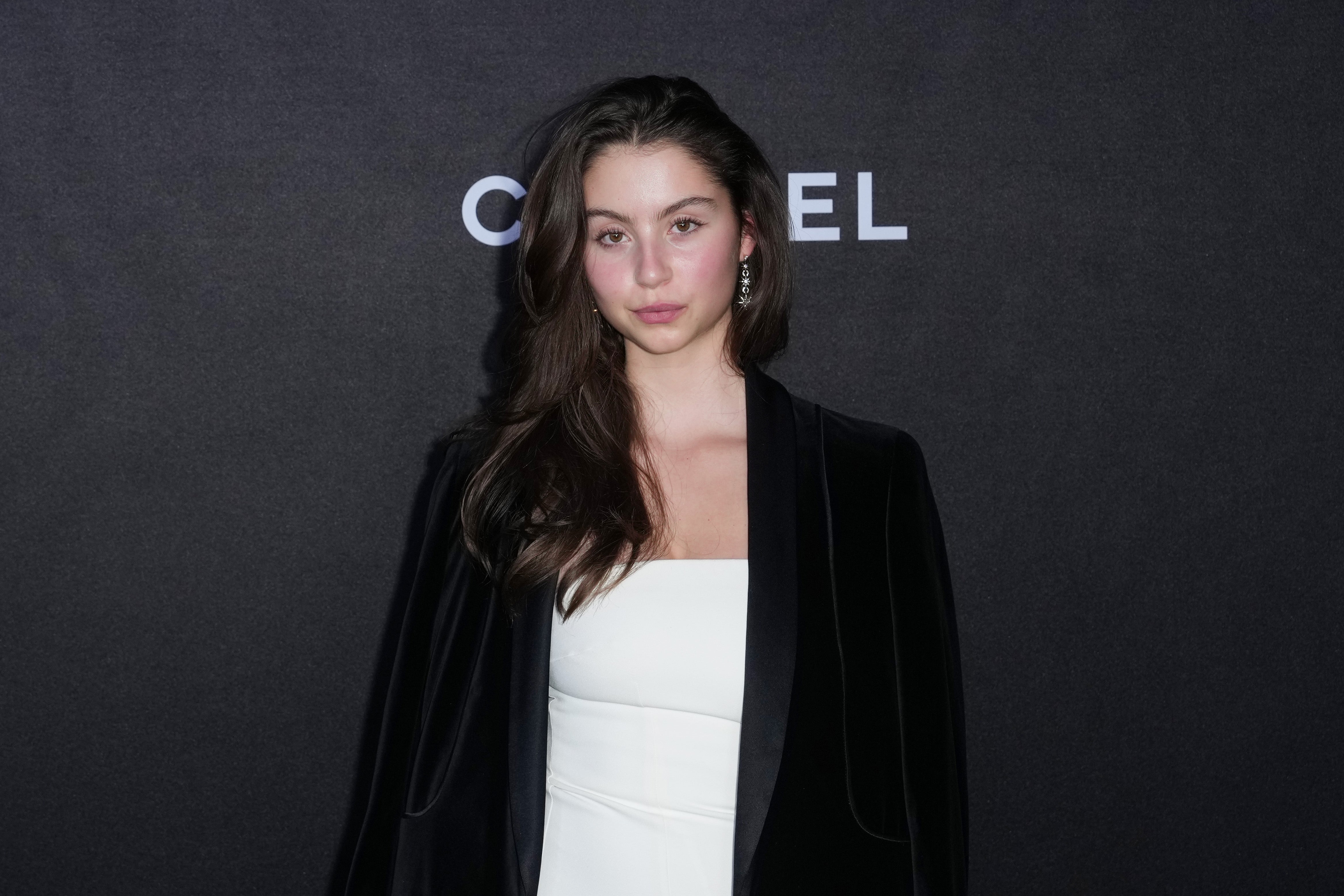 Person successful  a sleek achromatic  overgarment   implicit    a achromatic  outfit poses astatine  a Chanel event