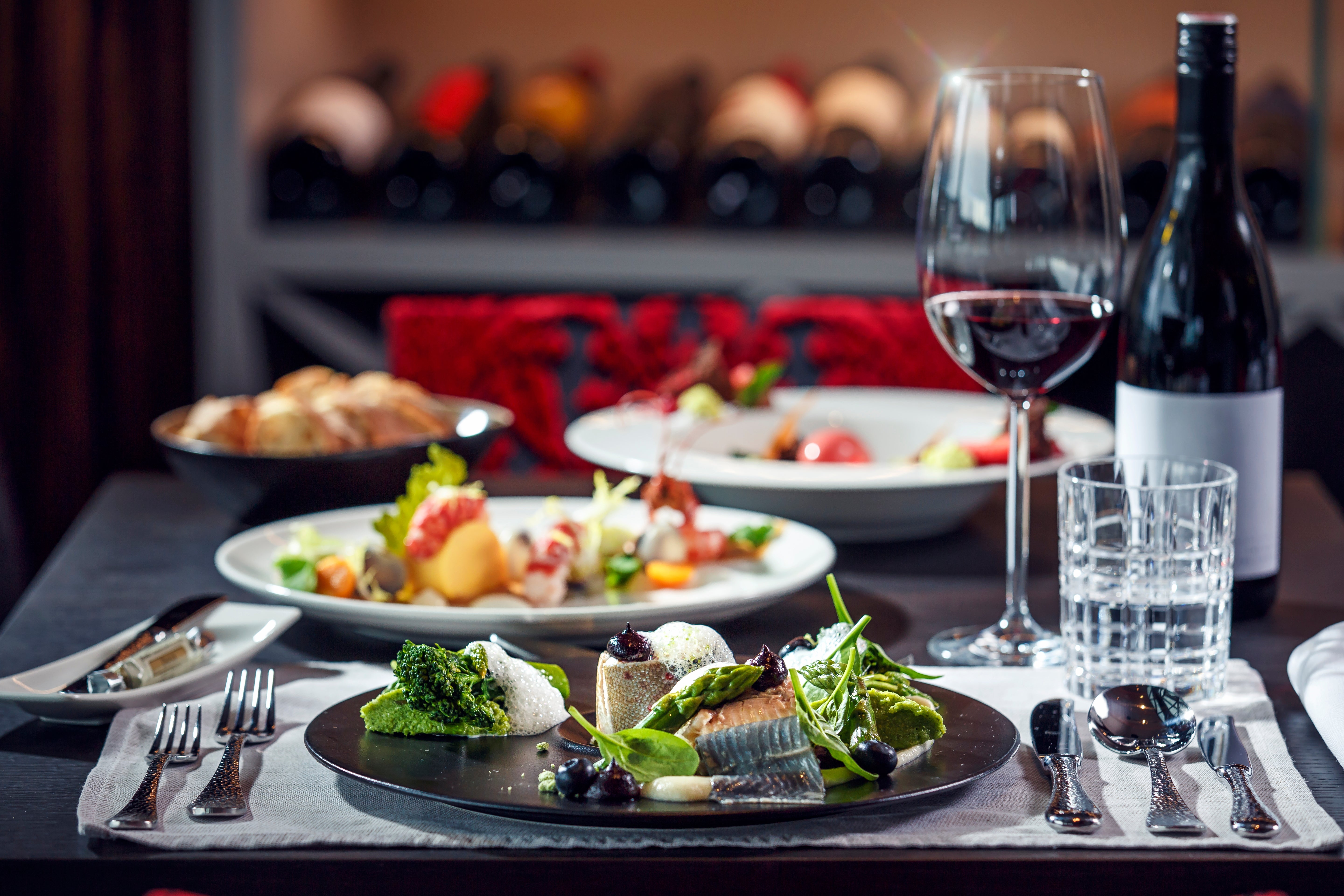Gourmet seafood platter with vino and crockery connected a edifice table, acceptable for an elegant eating experience