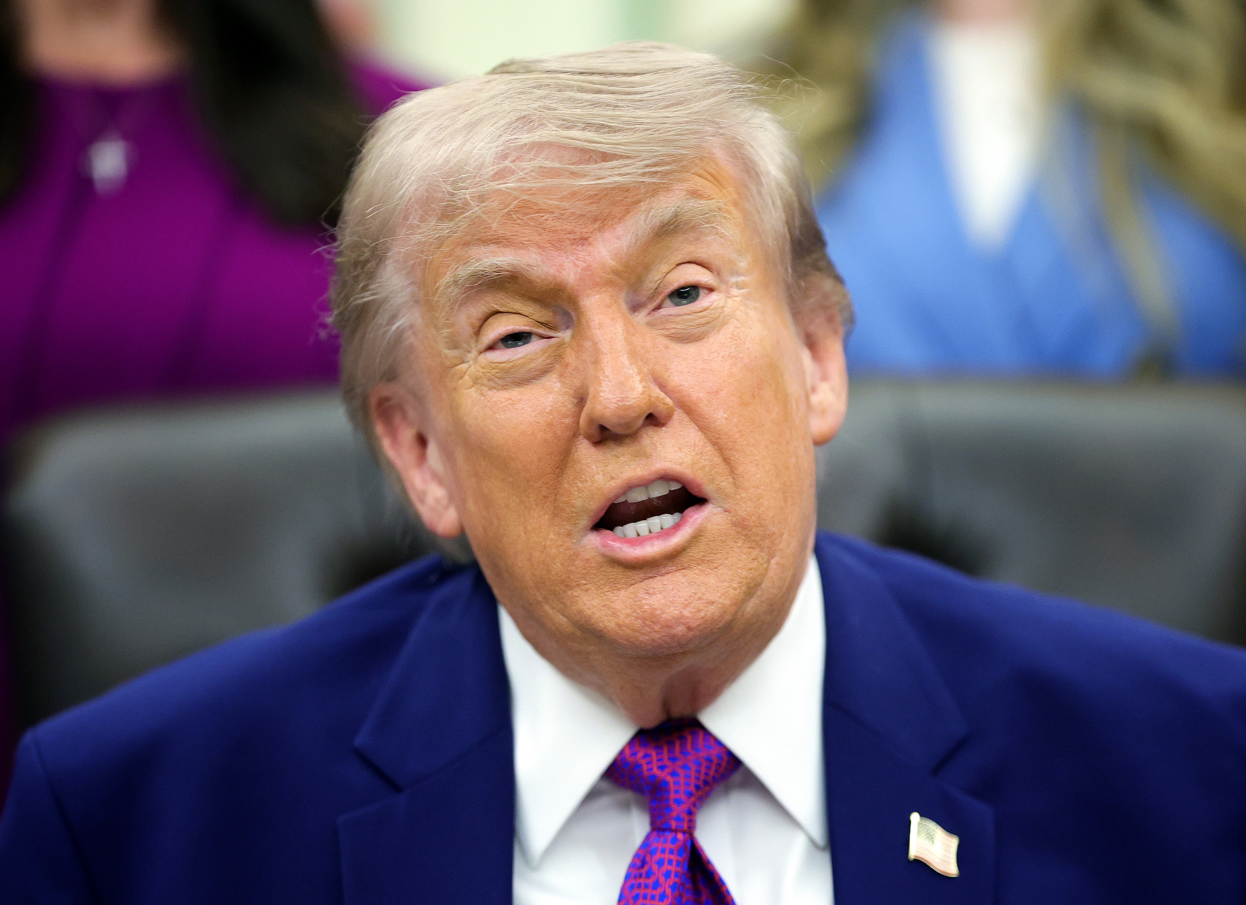 Person successful  a suit   and necktie  speaking, appearing engaged successful  a discussion, acceptable   against an indoor background