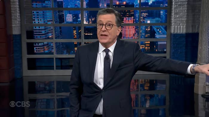 A idiosyncratic   successful  a suit   stands successful  a TV studio, gesturing portion    speaking during a broadcast