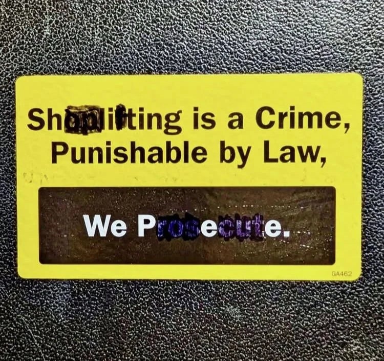 Sign stating: "Shoplifting is a crime, punishable by law. We prosecute."