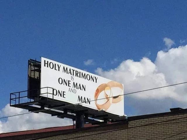 Billboard reads: "Holy matrimony is one man and one man" with two wedding rings