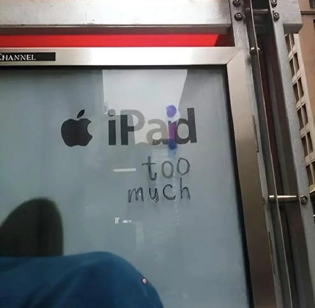 iPad advertisement altered to read "iPaid too much" with graffiti