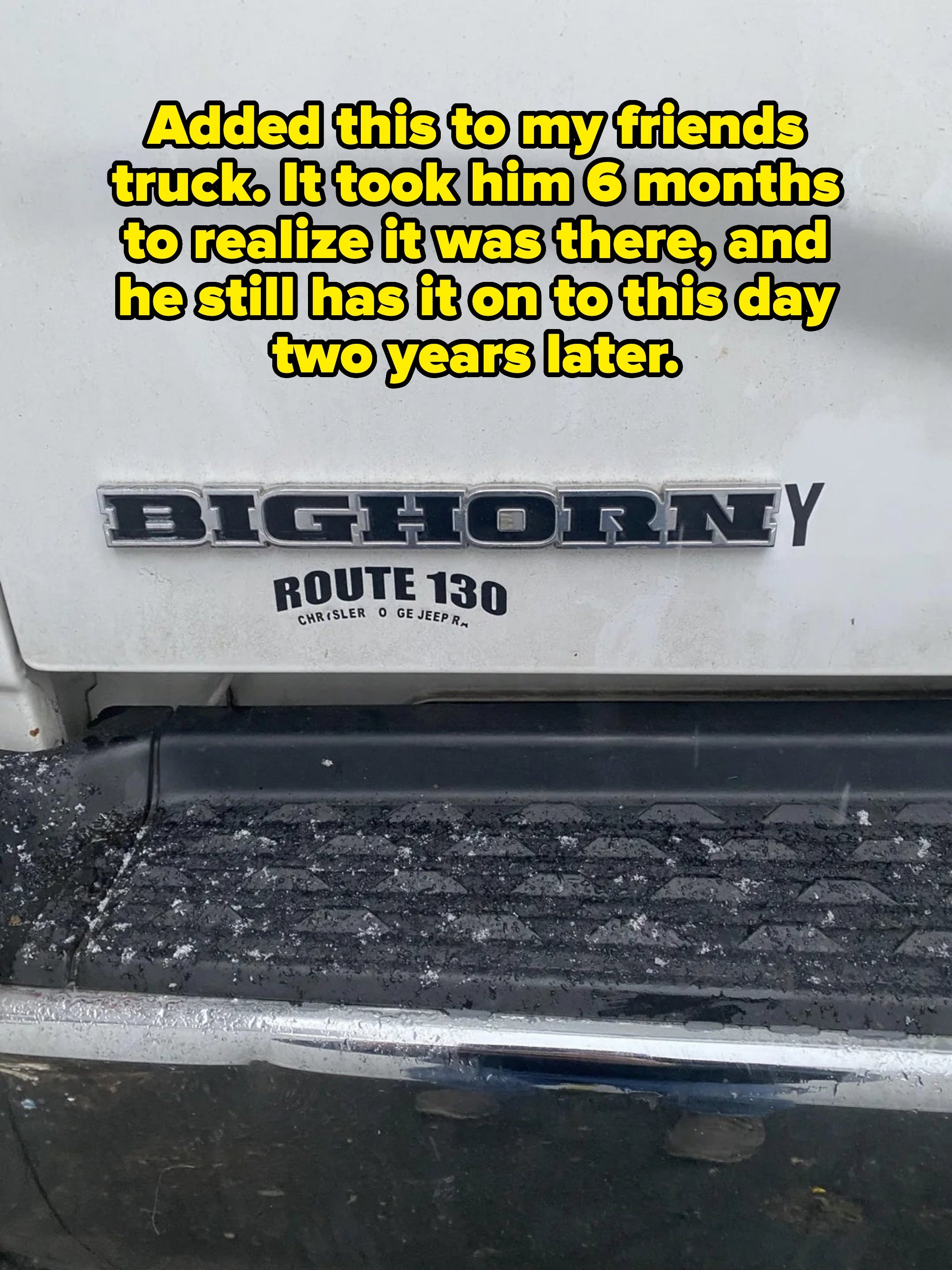 Close-up of a vehicle's rear showing "Bighorn" and "Route 130" badges with textured area below