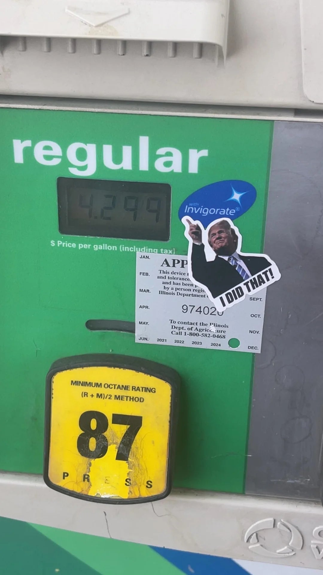 Gas pump showing price $4.29 per gallon. A sticker of a person pointing with "I did that!" is placed near the price display