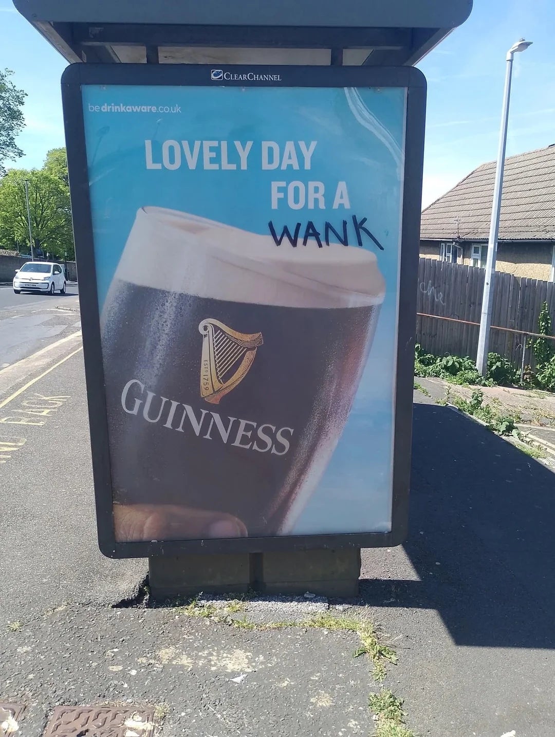 Billboard showing a pint of Guinness with the text "Lovely day for a" humorously altered to say "Lovely day for a wank."