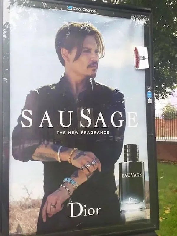 Billboard with a man in a black shirt and jewelry, featuring a parody fragrance ad for "Sausage" instead of "Sauvage" by Dior