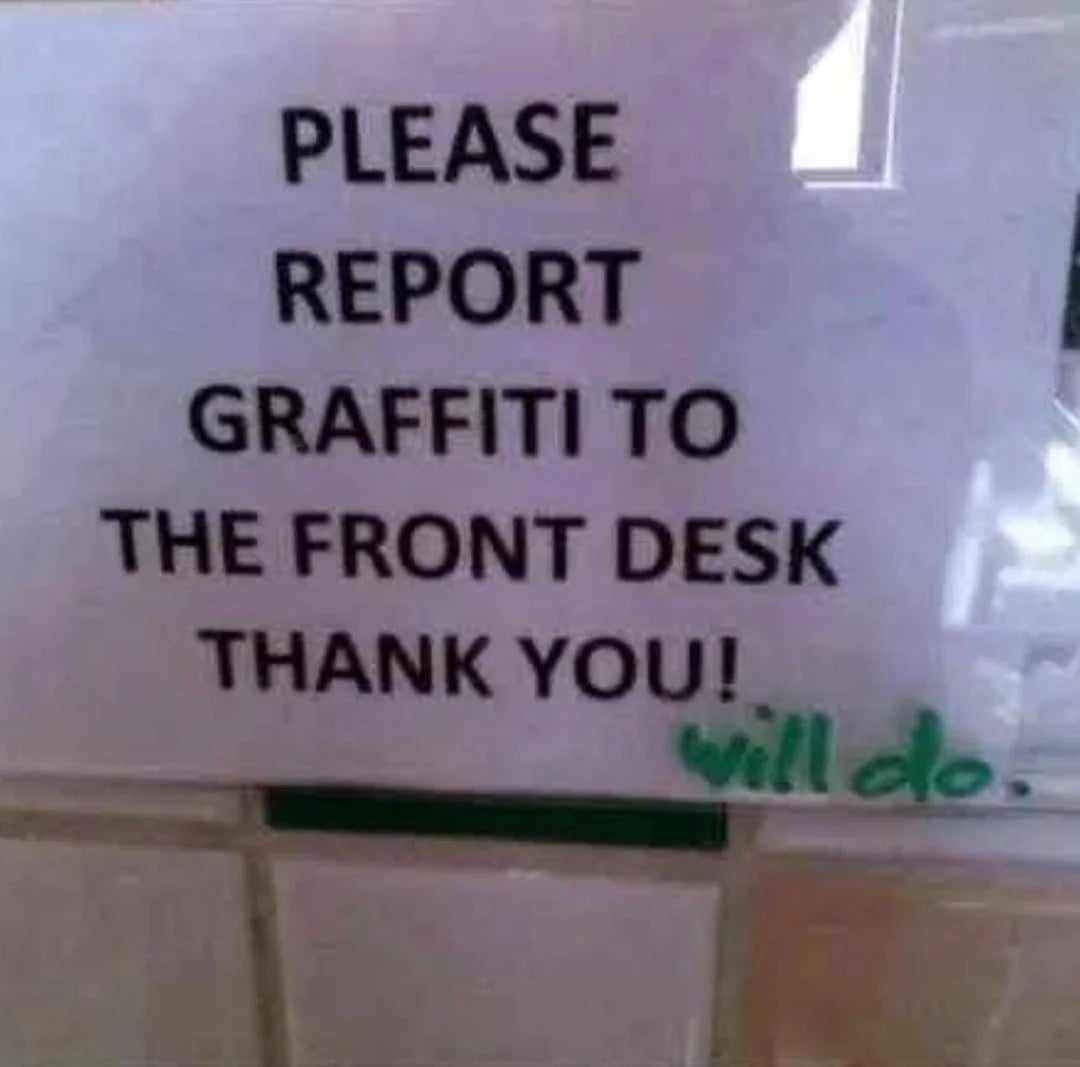 Sign asking to report graffiti to the front desk is humorously defaced with "will do" written below