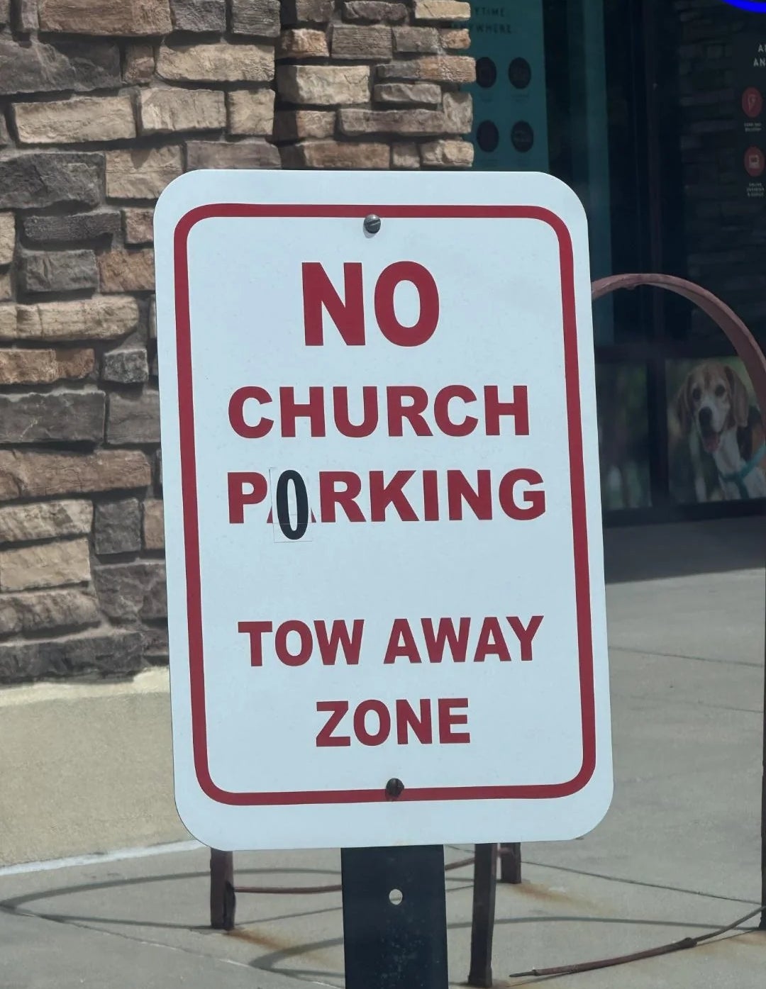 Sign outside says "No Church Parking Tow Away Zone."