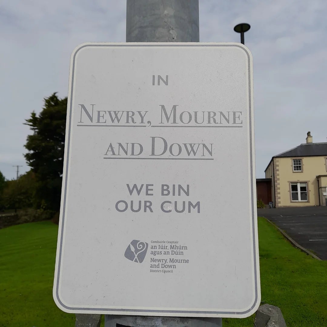 Sign reads, "In Newry, Mourne and Down, we bin our gum," with council logo below