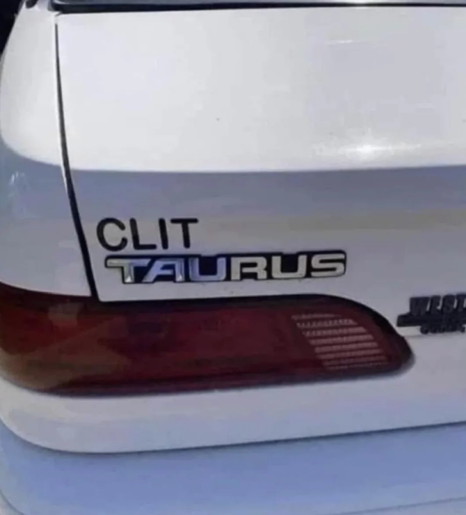 Car with altered rear badge reads "CLIT TAURUS."