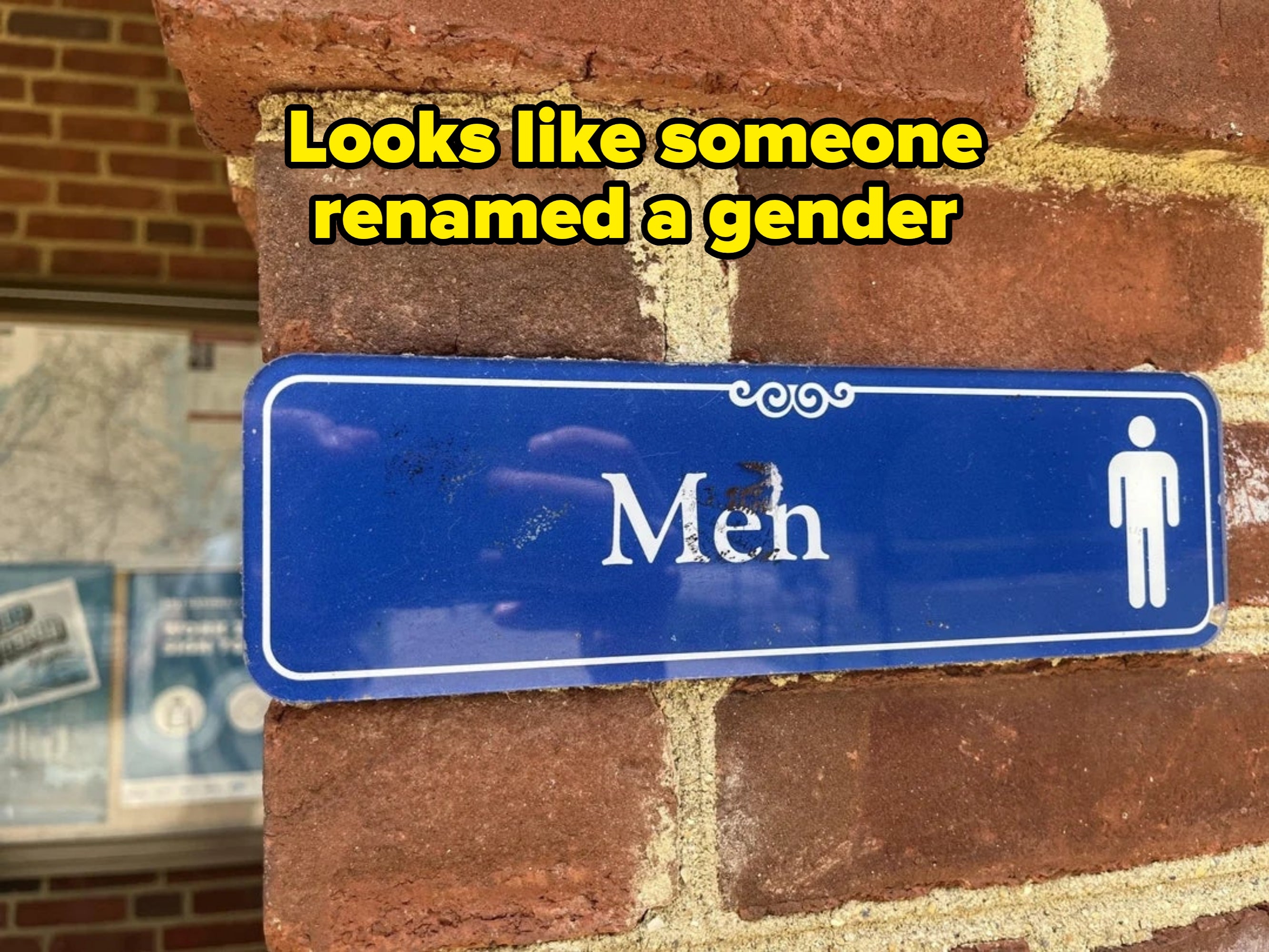 Sign on a brick wall reads "Men" with a male icon, indicating a men's restroom