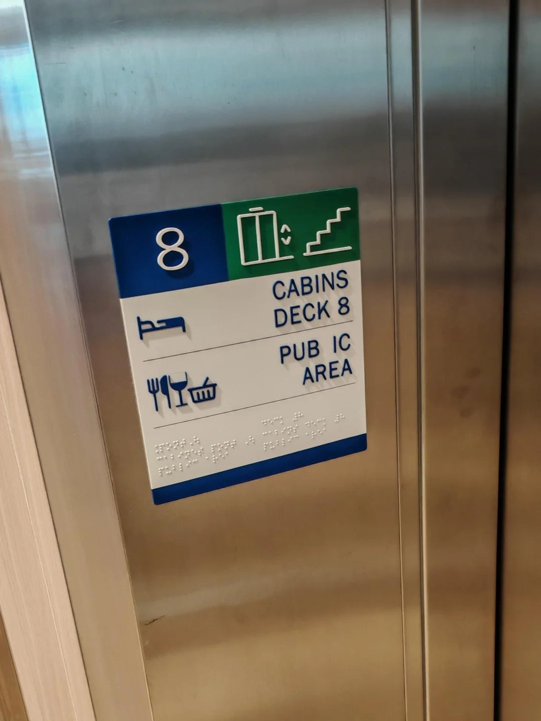 Elevator panel showing deck 8 with icons for cabins and public area, including a bed, stairs, and dining symbols