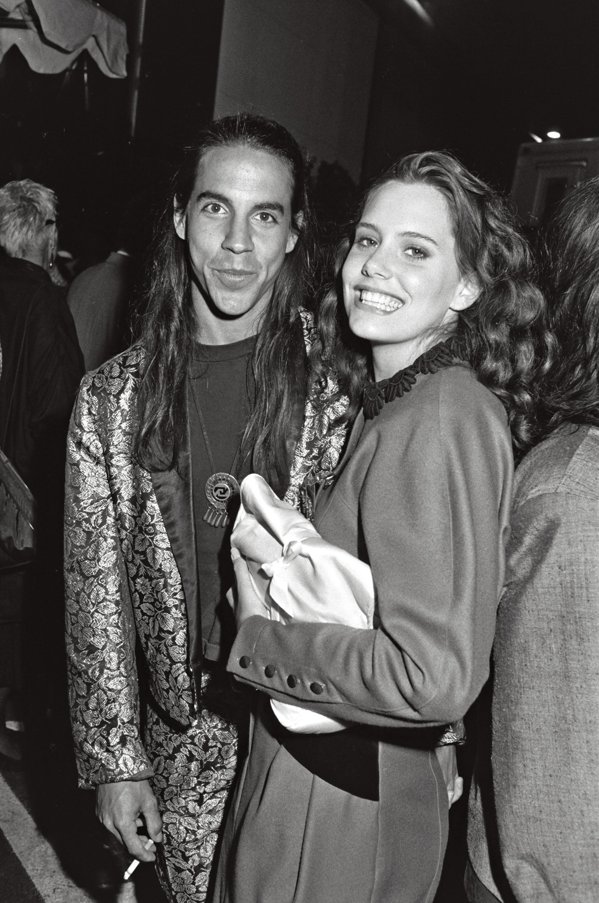 Two radical smiling astatine a reddish carpet event. The idiosyncratic connected the near wears a patterned jacket, portion the idiosyncratic connected the close wears an elegant dress