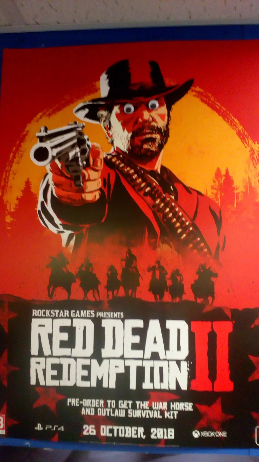 Poster for "Red Dead Redemption 2" shows a cowboy aiming a revolver, with a red background and game details at the bottom