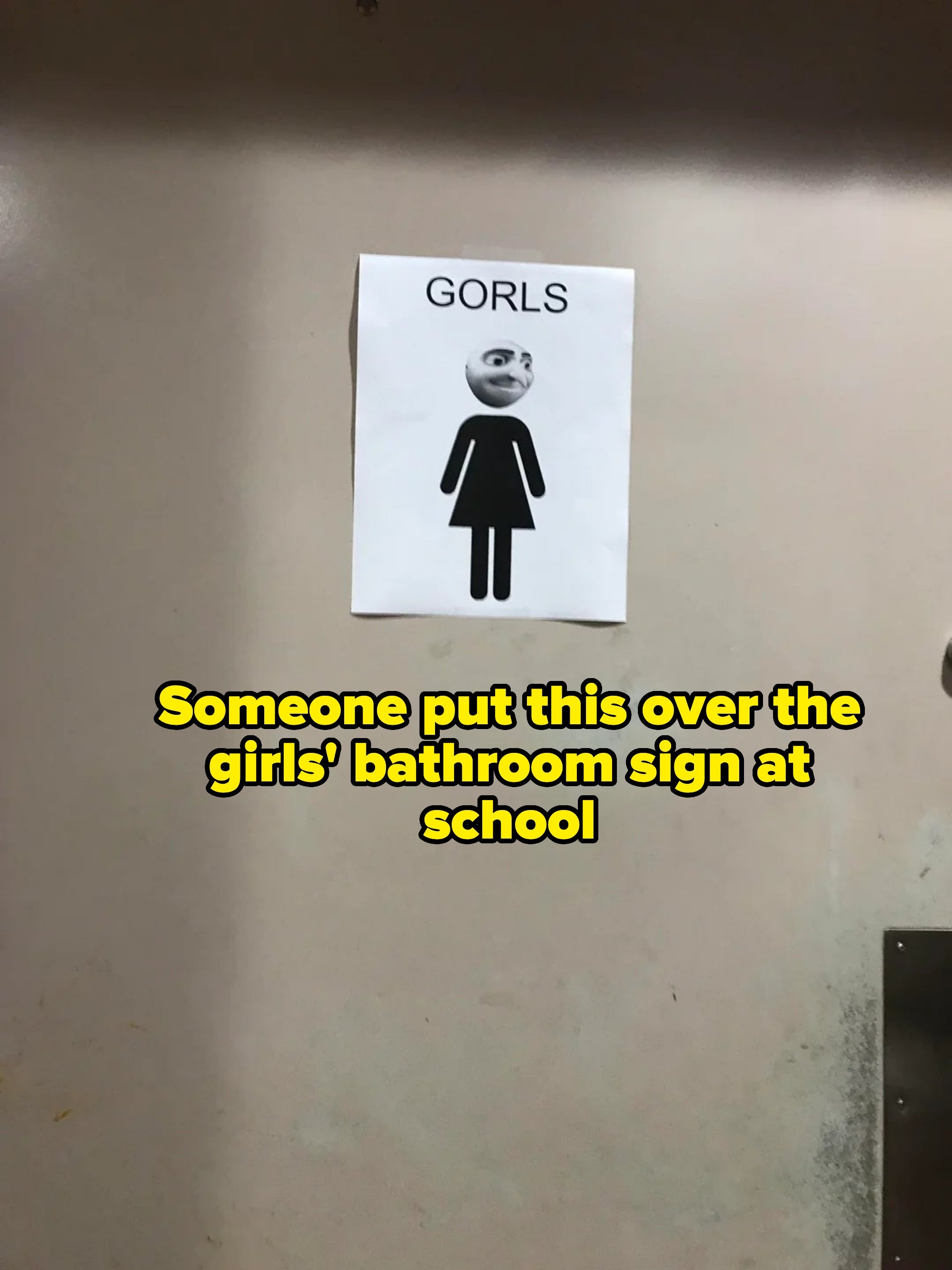 A sign on a wall shows a stick figure of a woman with a smiling face pasted on top, labeled "GORLS."
