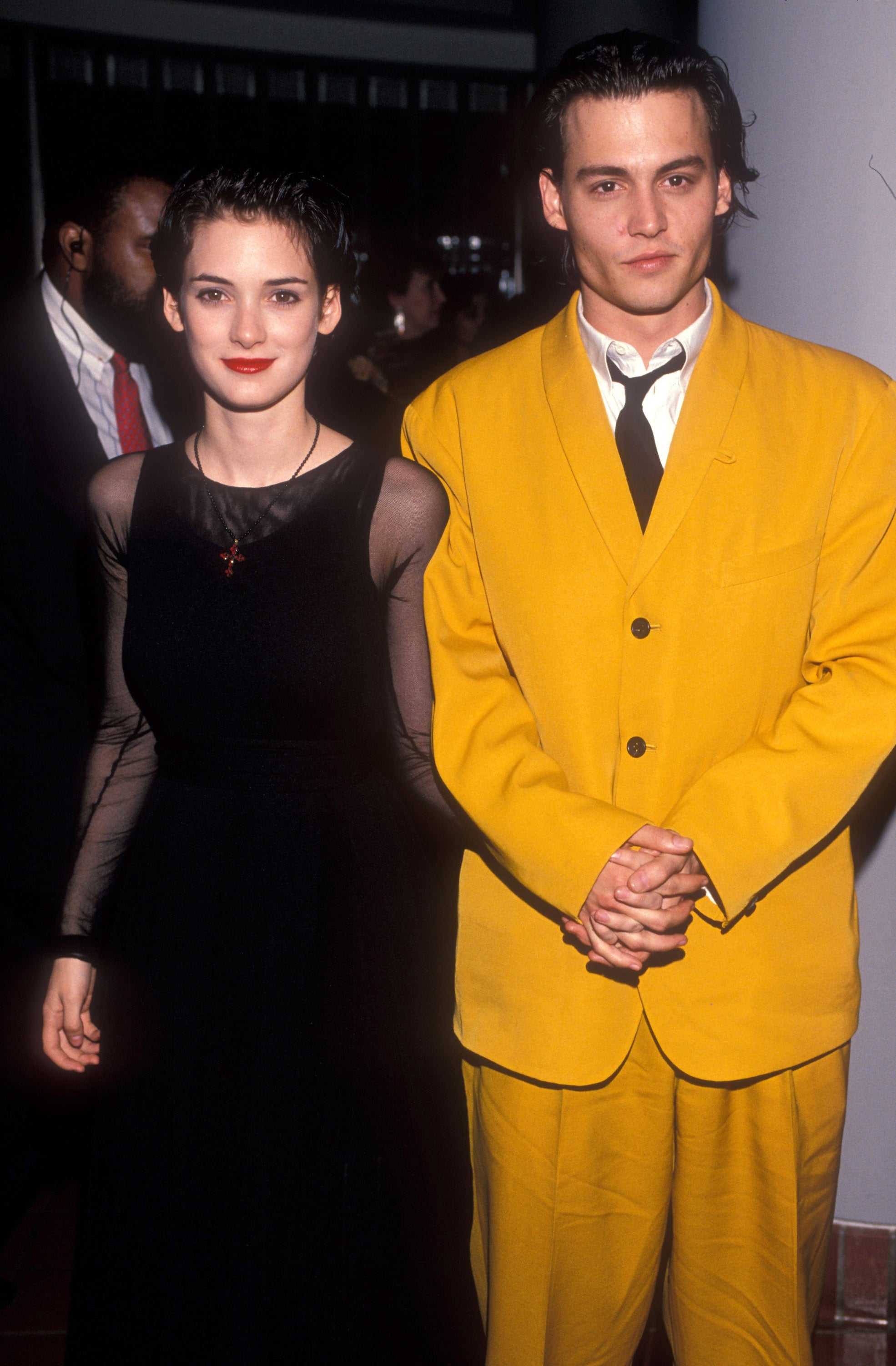 pistillate successful a sheer achromatic dress, antheral successful a bold yellowish suit with achromatic tie