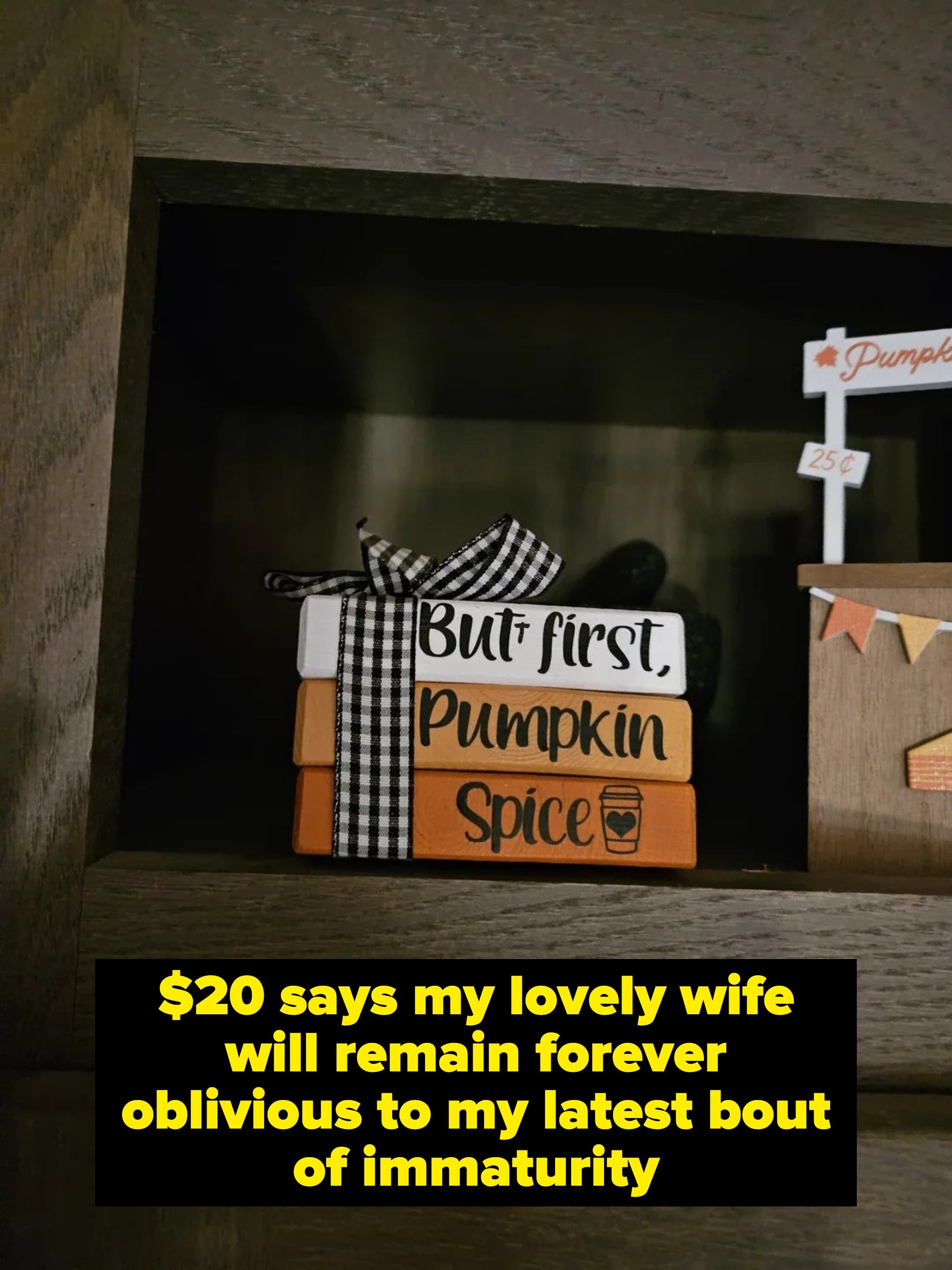Decorative blocks stacked with the text "But first, Pumpkin Spice" tied with a gingham ribbon, next to a small pumpkin sign