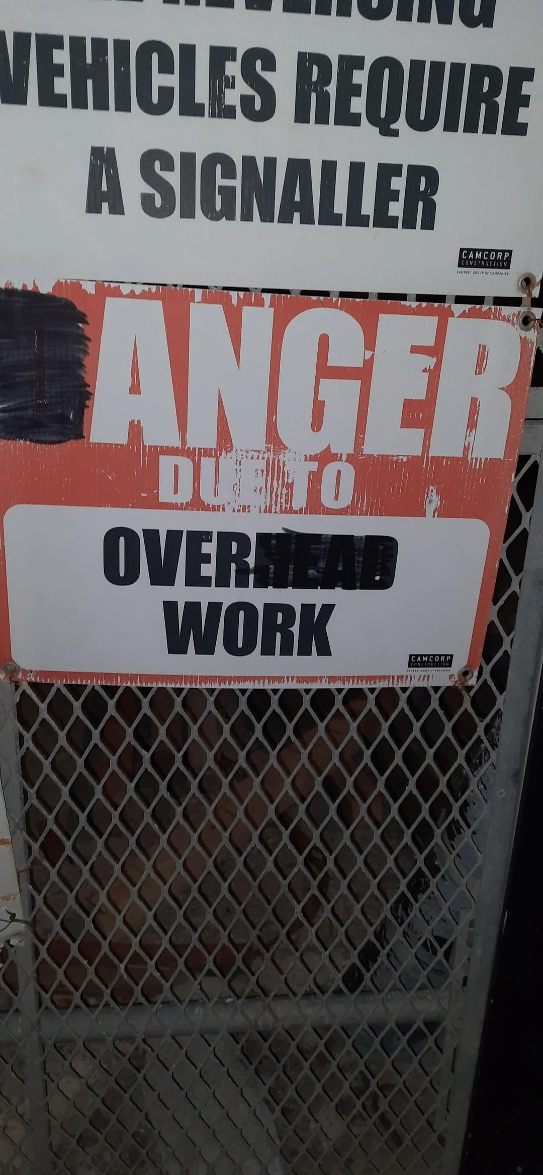 Warning sign about overhead work, advising caution due to potential falling objects or hazards above