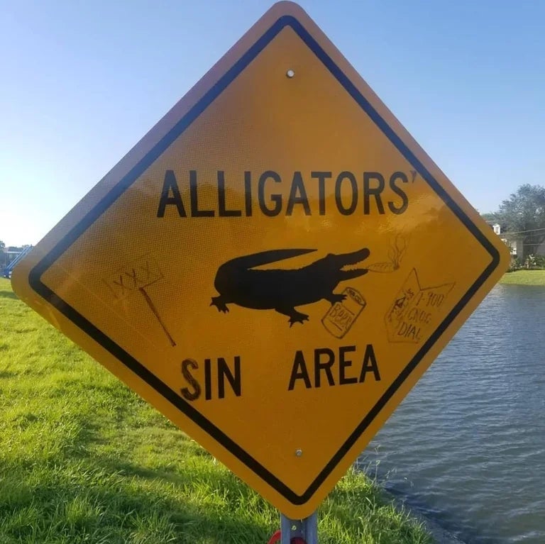 A humorous sign reads "Alligators' Sin Area" with graffiti of drawn alligators and text saying "Avoid long talks."
