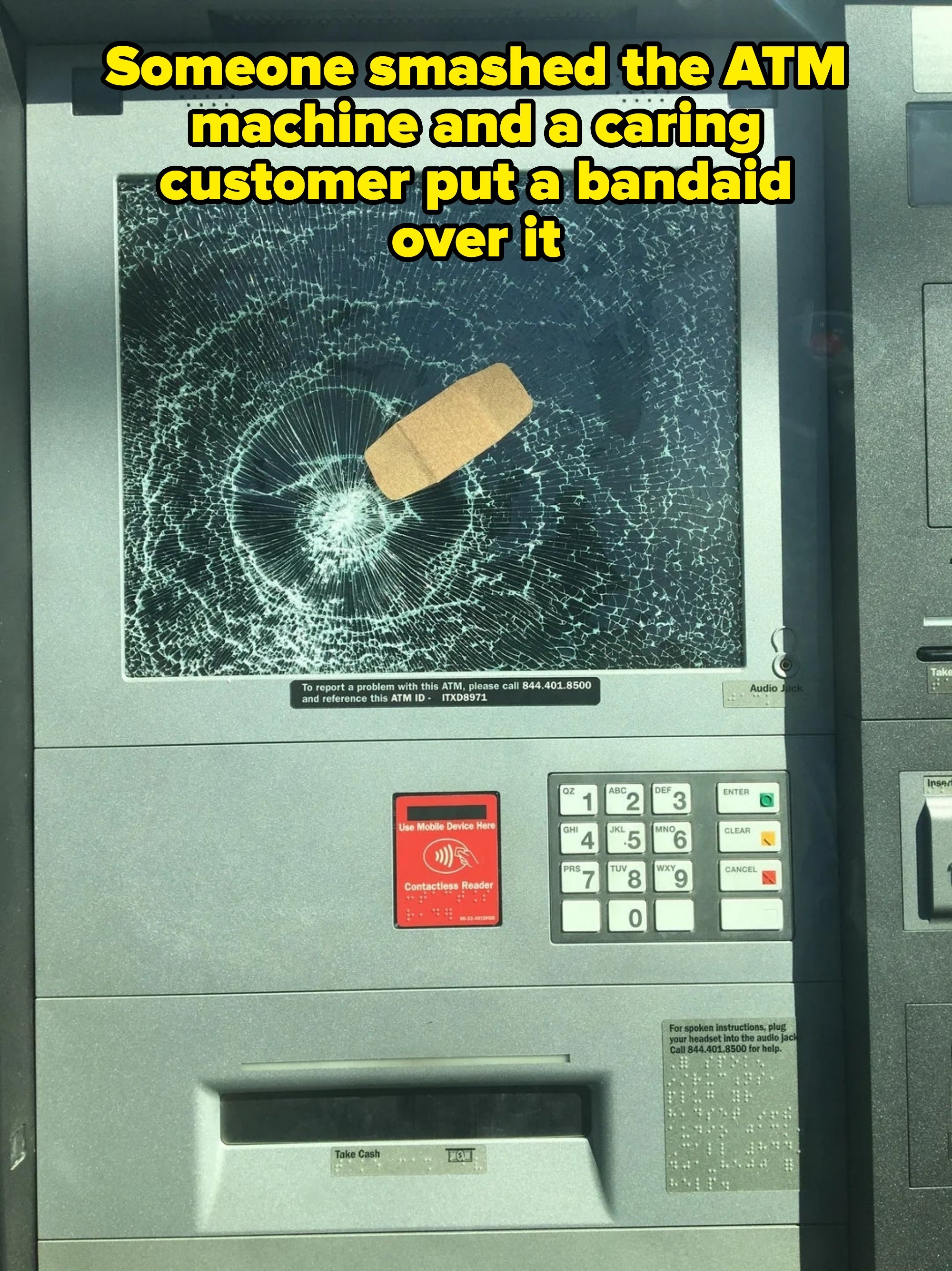 ATM screen is cracked with a bandage placed on it, keypad visible below