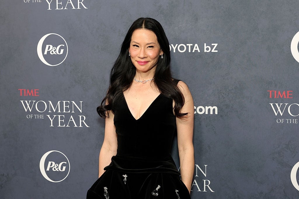 Person successful  elegant achromatic  gown attending a "Time Women of the Year" lawsuit   with a branded backdrop