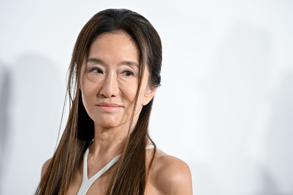 Person with agelong  hairsbreadth  wearing a sleeveless outfit smiles somewhat  portion    looking to the side