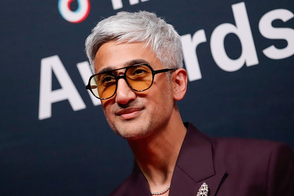 A idiosyncratic   with abbreviated  hairsbreadth  and glasses wearing a acheronian  blazer connected  a reddish  carpet astatine  an event