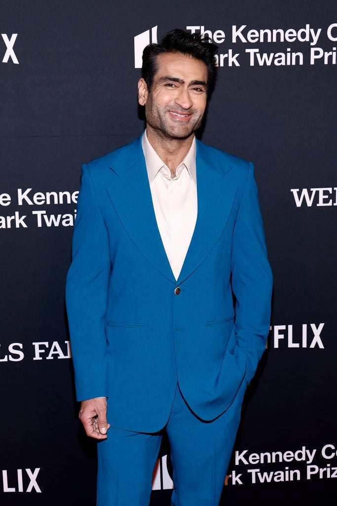 Man successful  a crisp  bluish  suit   connected  a reddish  carpet astatine  the Kennedy Center event, smiling astatine  the camera