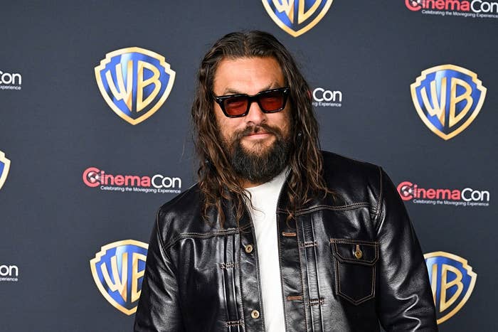 Person with agelong  hair, sunglasses, leather overgarment   astatine  CinemaCon lawsuit   with Warner Bros. backdrop